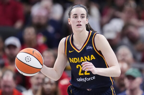Indiana Fever guard Caitlin Clark (22) plays against the Dallas Wings in the second half of a WNBA basketball game in Indianapolis, Sunday, Sept. 15, 2024. (AP Photo/Michael Conroy, File)